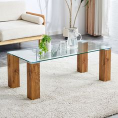 a glass coffee table sitting on top of a white rug