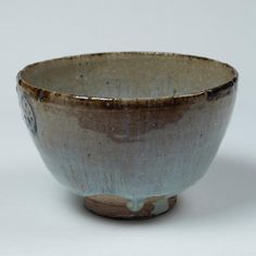 a brown and white bowl sitting on top of a table