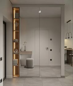 a modern bathroom with white walls and flooring is illuminated by recessed lighting in the corner