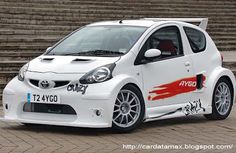 a small white car parked in front of some steps