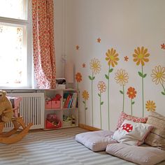 a child's bedroom with flowers painted on the wall