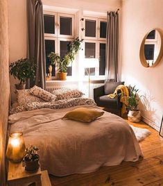 a bedroom with a bed, chair and window in it's centerpieces