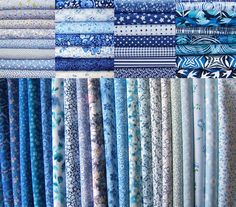 many different types of blue and white fabrics are stacked on top of each other in rows