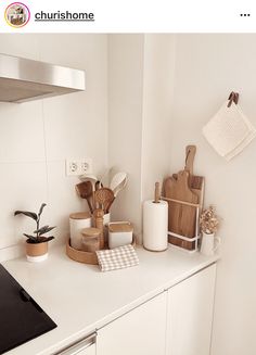 a kitchen counter with utensils and cutting boards on it