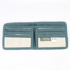 "Your wallet is your smallest accessory, but it can have the greatest vibes. This wallet is made of cotton canvas, making it durable and flexible. It has a full-length pocket perfect for bills and checks, and has smaller pockets that snugly fit your ID and cards. The Mushroom print is printed in an ombre style. Pair with a boho bag for a complete look of good vibes. Details: 100% Cotton 4\" high X 9\" wide (open) 4\" high x 4 1/2\" wide (folded) Made in Nepal" Casual Trifold Wallet For Daily Use, Casual Wallets With Card Slots, Casual Everyday Trifold Wallet With Card Slots, Casual Bifold Wallet For Everyday Use, Casual Everyday Wallets With Pockets, Casual Green Wallets For Everyday Use, Casual Green Wallet For Everyday Use, Casual Green Wallet For Daily Use, Casual Bifold Travel Wallets