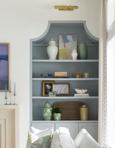 a living room filled with furniture and bookshelves