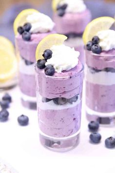 no bake blueberry cheesecake in a glass with lemon slices and whipped cream