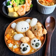 some food is in a bowl on a table next to a spoon and two bowls