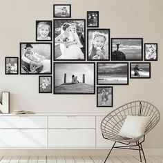 a white room with many pictures on the wall and a chair in front of it