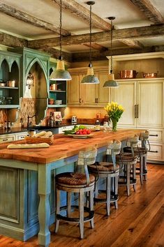 a large kitchen with an island in the middle and lots of counter space on one side