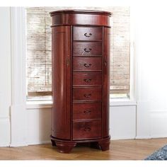 a tall wooden cabinet sitting in front of a window