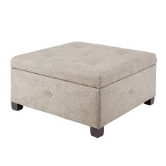 an ottoman with buttons on the top and legs, in light gray linen fabric upholstered