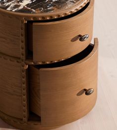 a wooden table with three drawers on the top and one drawer open to show what's inside