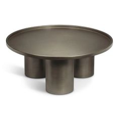 a round metal table with three legs on the bottom and one leg raised to the side