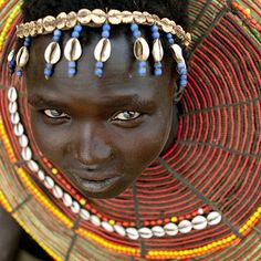 an african woman with blue eyes and headdress