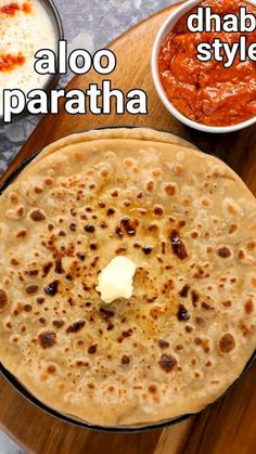 there is a plate with some food on it and the words aloo paratha