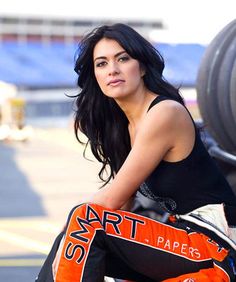 a beautiful woman sitting on top of a motorcycle