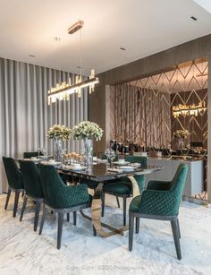 an elegant dining room with green chairs and marble flooring is pictured in this image