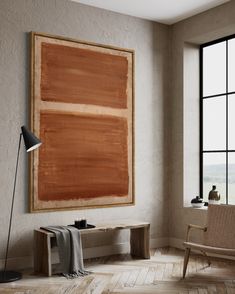 an empty room with a large painting hanging on the wall and two chairs in front of it