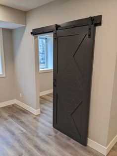 Walston Door Company Painted Door Painted Modern Arrow Door Modern Barn Door Grey, Grey Painted Barn Doors, Barn Door With Chalkboard Paint, Barn Door With Window Painted, Gray Painted Barn Door, Modern Barn Door Bathroom, Herringbone Door, Barn Door Bathroom, Grey Hallway