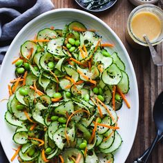 a white plate topped with cucumbers and carrots