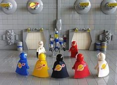 several lego figures are lined up in a room