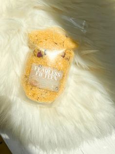 a bag of food sitting on top of a white fur covered floor