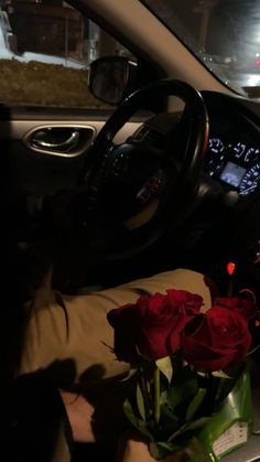 a bunch of roses sitting in the passenger seat of a car