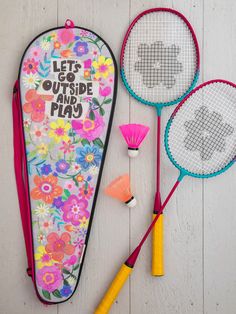 two tennis racquets and a case with the words let go outside and play