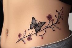 a woman's stomach with a butterfly tattoo on the side and flowers growing out of it