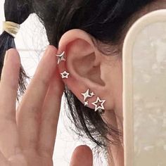 a close up of a person's ear with three stars on it