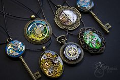 several different types of necklaces on a black surface with key attached to the chain