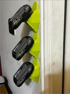 three black and yellow skateboards mounted to the side of a wall