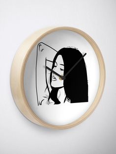 a clock with a woman's face drawn in black and white on the front