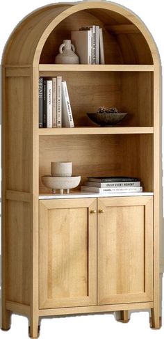 a wooden book shelf with books on top of it and a bowl next to it