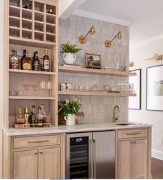 a kitchen filled with lots of counter top space next to a wine rack and refrigerator