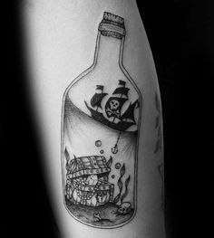 a black and white photo of a bottle with a pirate ship in it on the arm