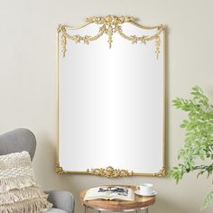 a mirror sitting on top of a wall next to a chair and potted plant