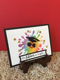 a handmade card with an image of a graduate's hat and sunglasses on it