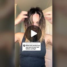 a woman with long hair is looking at the camera and has an ad on her t - shirt