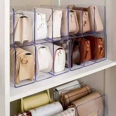 several clear bins holding purses and handbags in a white closet with shelves