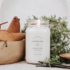 a candle sitting on top of a wooden bowl