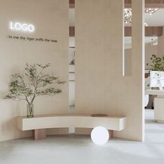 a white circular bench sitting in front of a wall with a sign on it that says logo