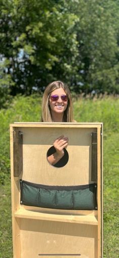 a woman standing in front of a cardboard box