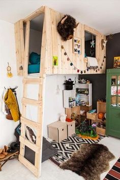 a loft bed made out of wooden pallets in a room with other items on the floor