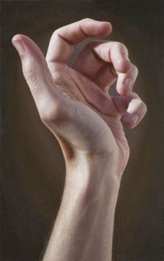 a person's hand holding something in the air