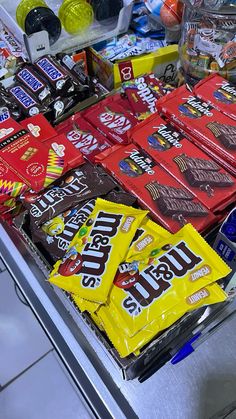 a display case filled with lots of different types of candy bar wrappers and candies