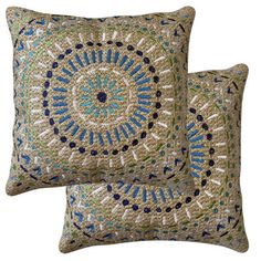 two decorative pillows with blue and green designs