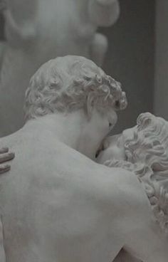 a statue of two men embracing each other