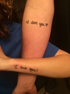 two people with arm tattoos that say i love you